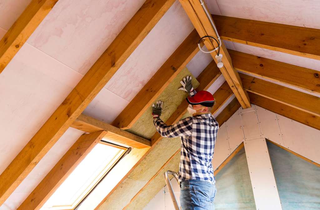 Roofer installing an insulation